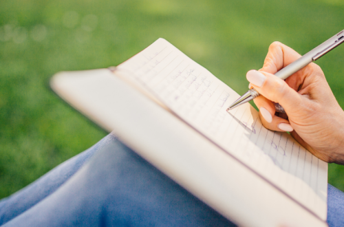 meditations with an ink pen banner: person writing verses in a notebooks